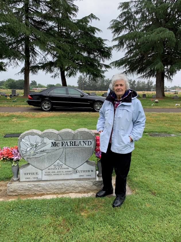 Mom at Grandpa and Grandma's headstone